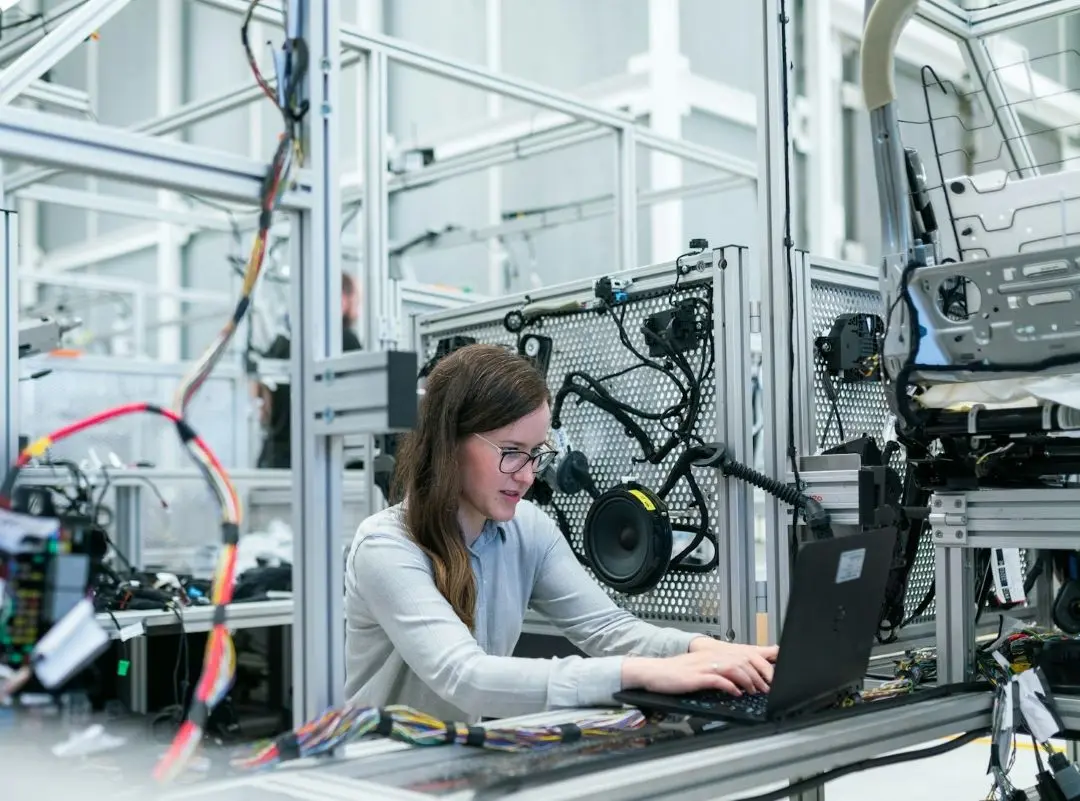 Female engineer does some tasks on a laptop.