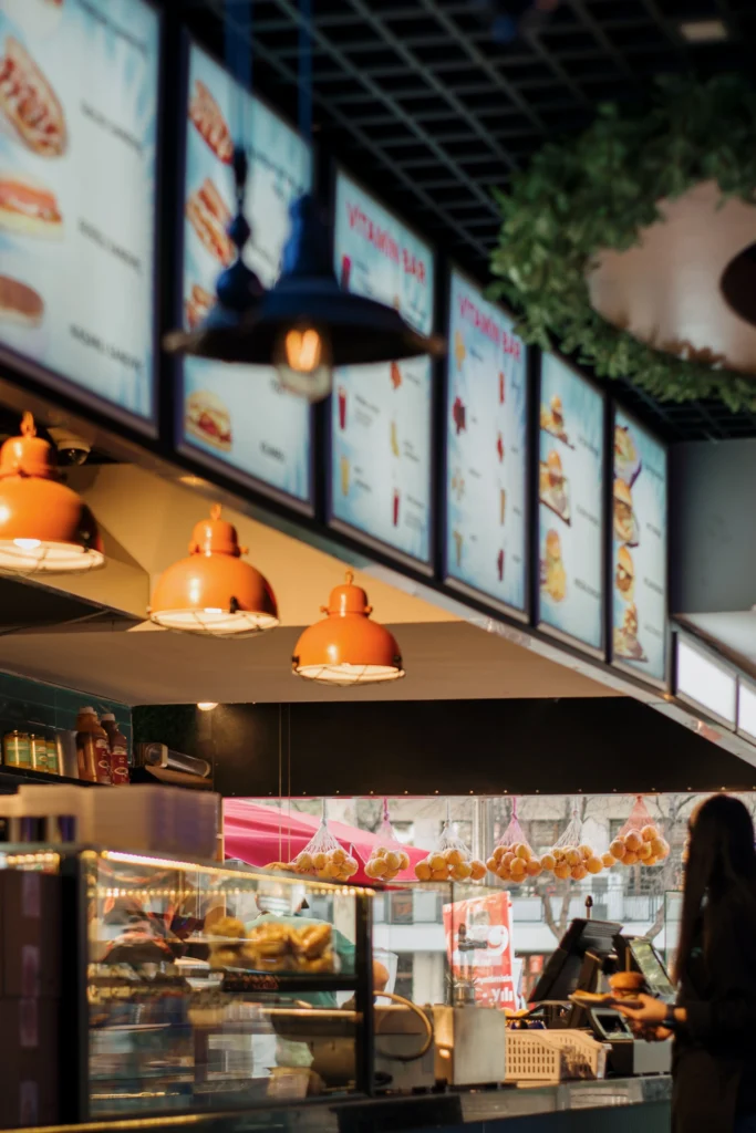 An interior shot of a Restaurant with multiple digital menu boards above the counter.